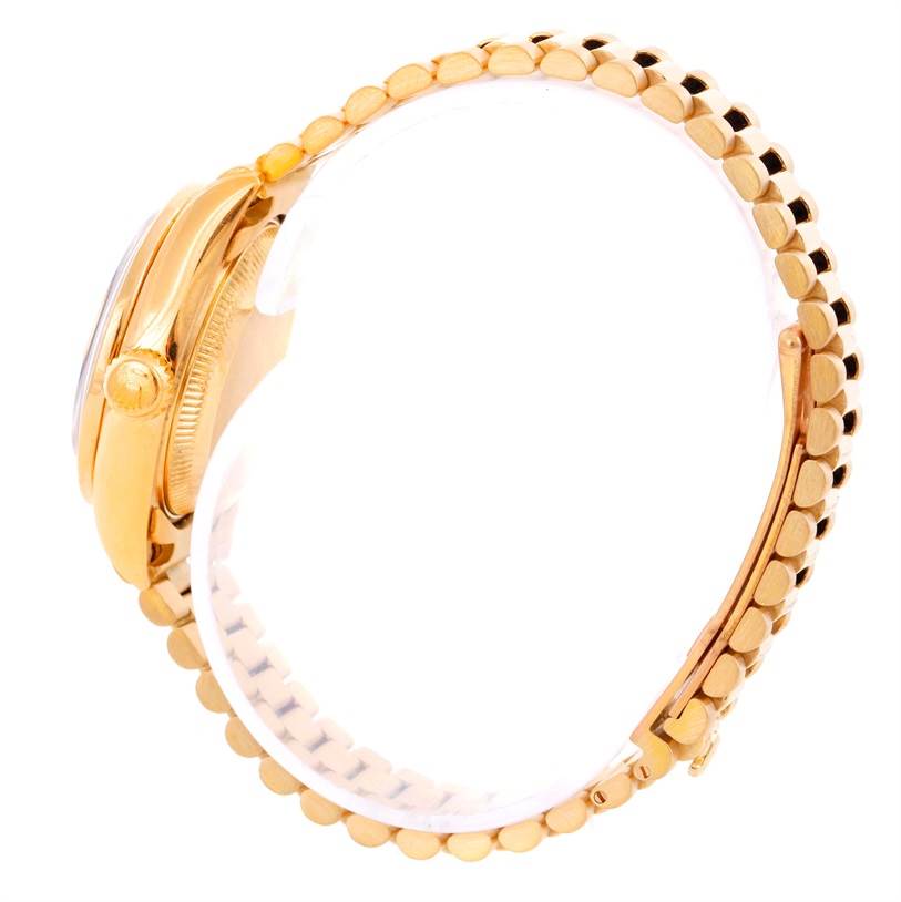 The image shows a side view of a Rolex President 69178 Women's Yellow Gold Black Dial 69178 Women's Yellow Gold Black Dial model watch, displaying the side case and bracelet with a clear view of the crown.