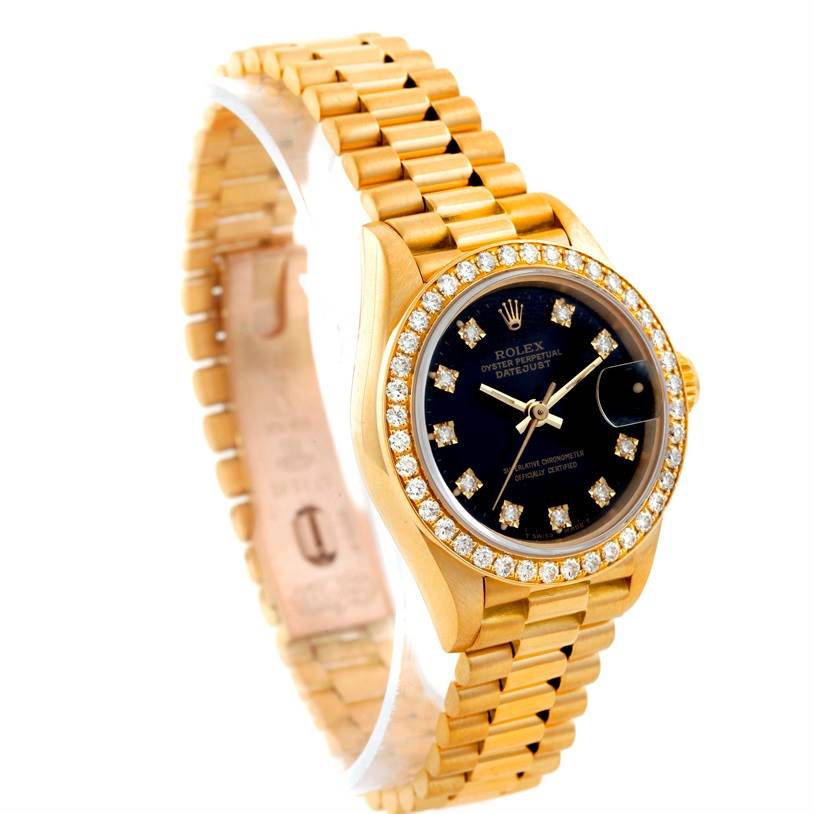 The image shows a Rolex President 69178 Women's Yellow Gold Black Dial 69178 Women's Yellow Gold Black Dial model watch at a three-quarter angle, highlighting its gold bracelet, diamond bezel, and black dial.