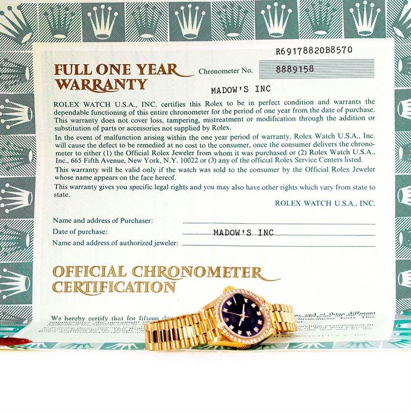 The image shows a Rolex President 69178 Women's Yellow Gold Black Dial 69178 Women's Yellow Gold Black Dial model watch laid flat alongside its warranty and chronometer certification documents.