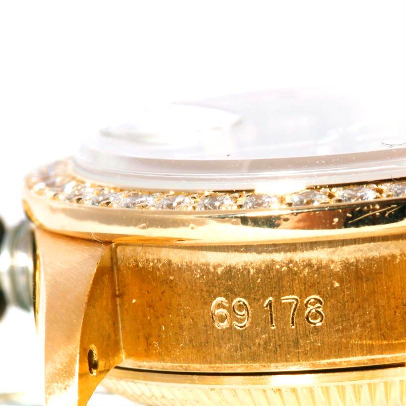 This close-up image of a Rolex President 69178 Women's Yellow Gold Black Dial 69178 Women's Yellow Gold Black Dial watch shows the side of its gold case with the model number 69178 engraved.