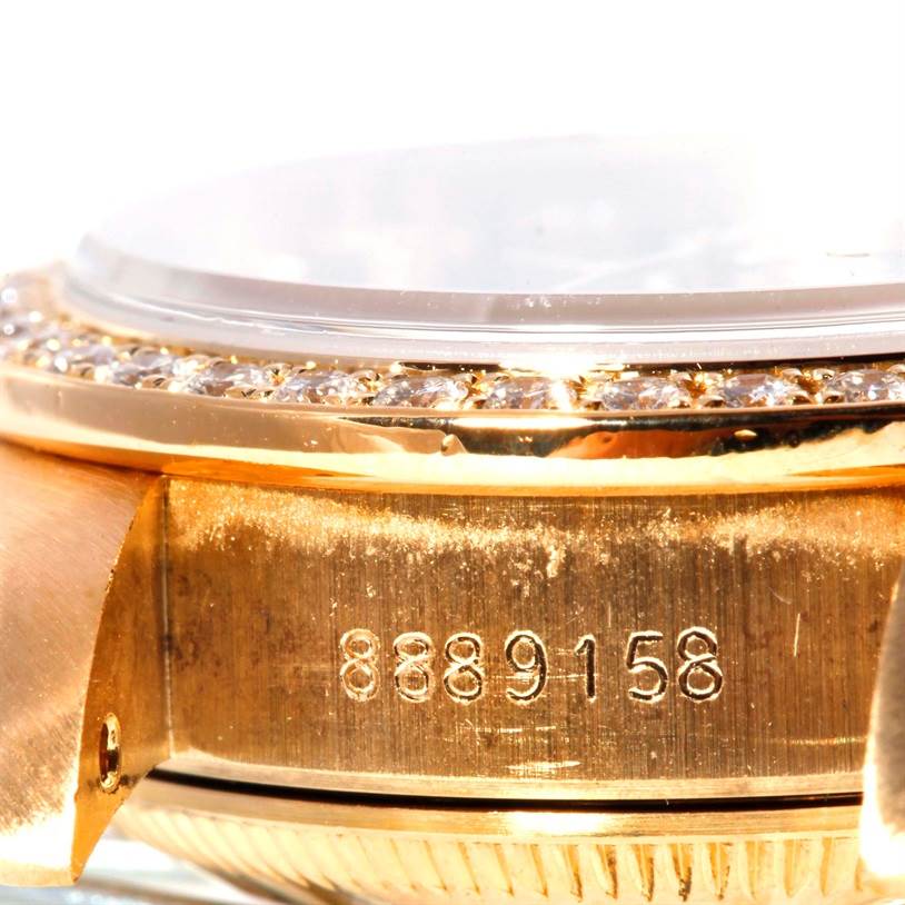 The close-up image shows the side of a Rolex President 69178 Women's Yellow Gold Black Dial 69178 Women's Yellow Gold Black Dial model watch, highlighting the bezel, case, and part of the serial number.