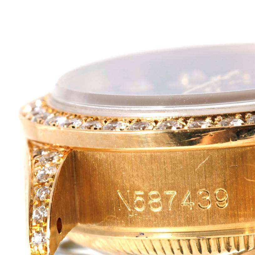 This image shows a close-up angle of the case and serial number of a Rolex President 69188 Women's Yellow Gold Blue Dial 69188 Women's Yellow Gold Blue Dial model watch with diamond accents.