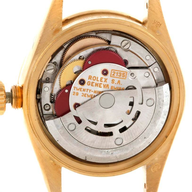 This image shows the inner mechanism of a Rolex President 69188 Women's Yellow Gold Blue Dial 69188 Women's Yellow Gold Blue Dial model watch from a top-down angle, displaying gears and inscriptions.
