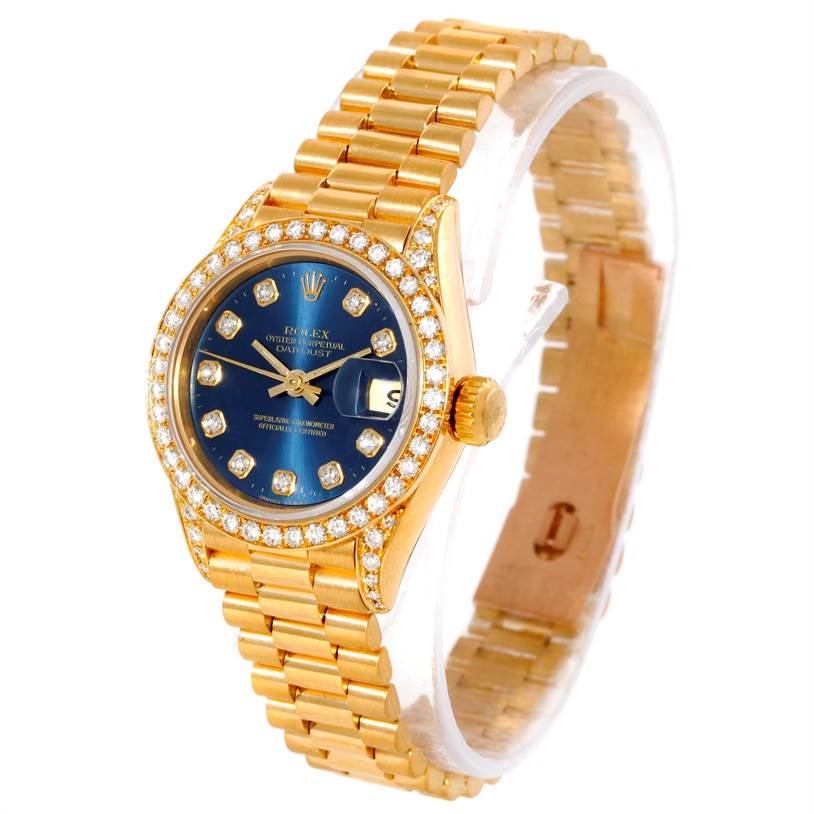 The image shows a Rolex President 69188 Women's Yellow Gold Blue Dial 69188 Women's Yellow Gold Blue Dial model watch at an angled side view, highlighting the blue dial, diamond bezel, and gold bracelet.