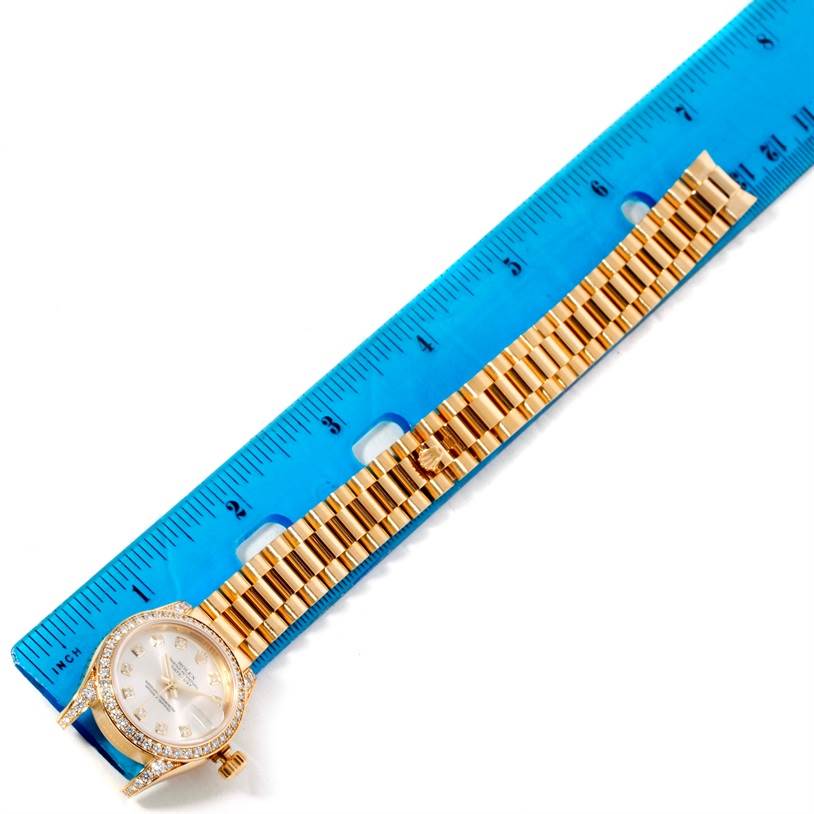 The image shows a Rolex President 179298 Women's Yellow Gold Silver Dial 179298 Women's Yellow Gold Silver Dial model watch laid flat with a blue ruler for measurement.