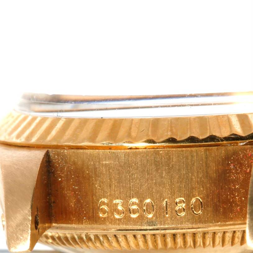 This close-up shows the side of the Rolex President 6917 Women's Yellow Gold Champagne Dial 6917 Women's Yellow Gold Champagne Dial model watch case, highlighting its serial number and part of the bezel.