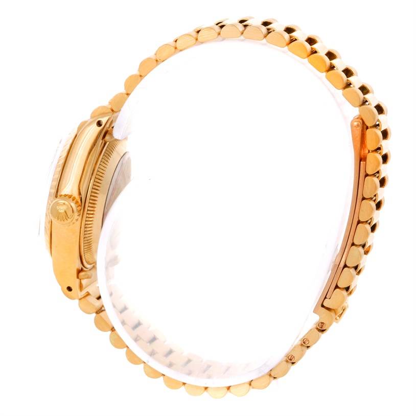 The image shows the side view and part of the bracelet of a Rolex President 6917 Women's Yellow Gold Champagne Dial 6917 Women's Yellow Gold Champagne Dial model watch.