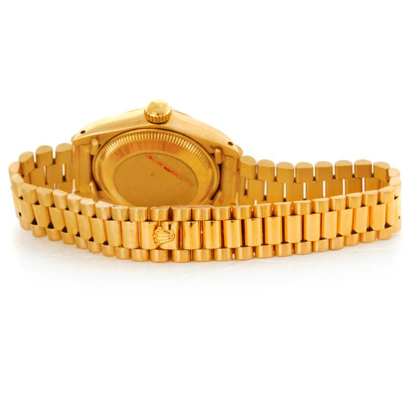 The image shows the back of a Rolex President 6917 Women's Yellow Gold Champagne Dial 6917 Women's Yellow Gold Champagne Dial model watch, highlighting the bracelet and case back.