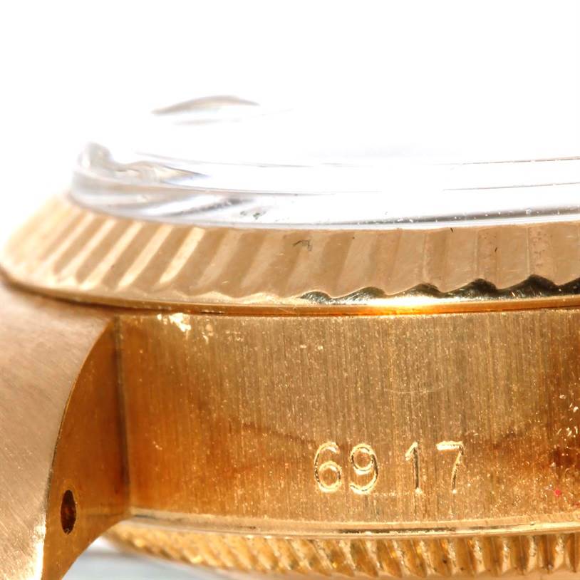 The image shows a close-up side view of a Rolex President 6917 Women's Yellow Gold Champagne Dial 6917 Women's Yellow Gold Champagne Dial watch, highlighting its gold casing and bezel.
