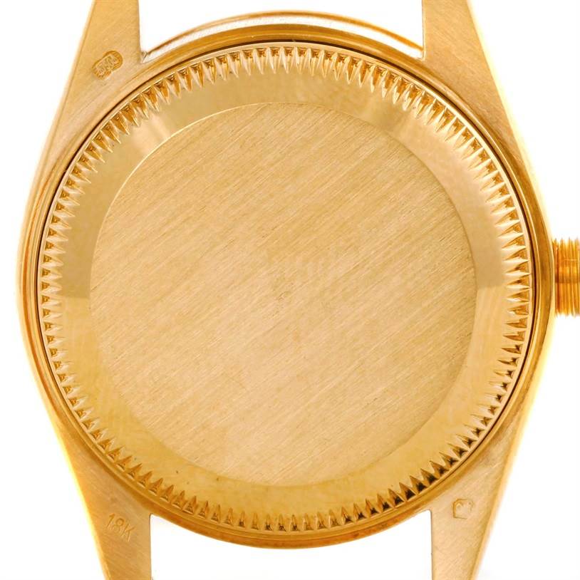 This image shows the back case of a Rolex President 69178 Women's Yellow Gold Champagne Dial 69178 Women's Yellow Gold Champagne Dial model watch from a top-down angle.