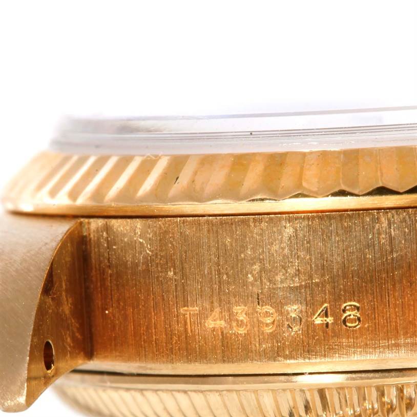 Close-up of the side view of a Rolex President 69178 Women's Yellow Gold Champagne Dial 69178 Women's Yellow Gold Champagne Dial model, showing the serial number and part of the bezel and case.