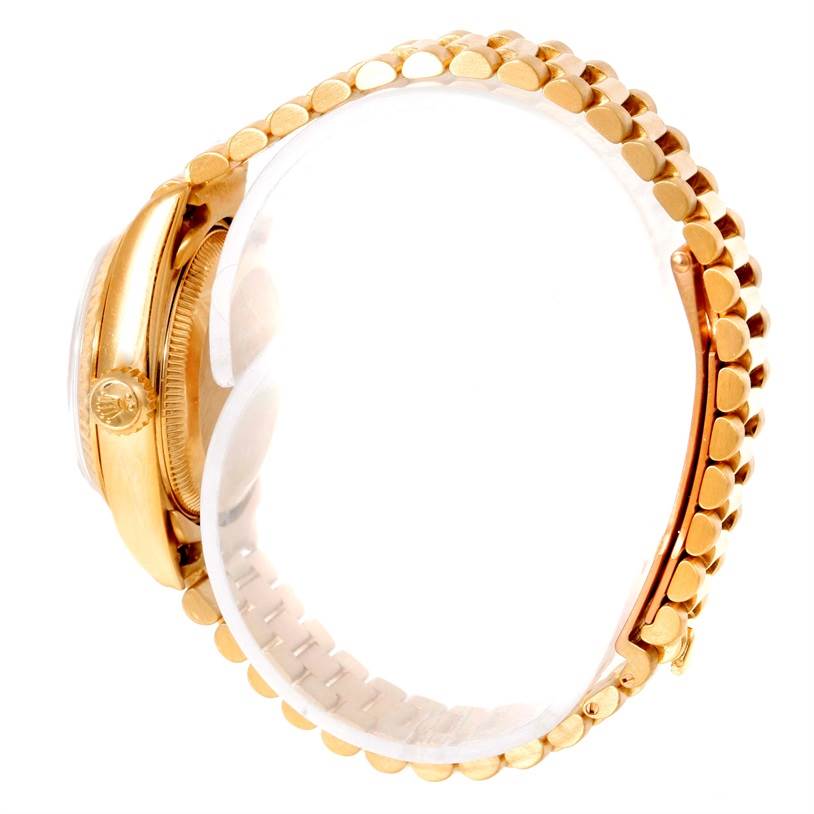 This is a side view of a Rolex President 69178 Women's Yellow Gold Champagne Dial 69178 Women's Yellow Gold Champagne Dial model watch, showing the crown, case, and bracelet.