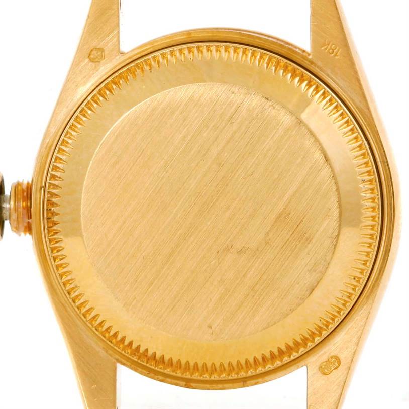 This image shows the back case and part of the crown of a Rolex President 69178 Women's Yellow Gold Silver Dial 69178 Women's Yellow Gold Silver Dial model watch, taken from a top-down angle.