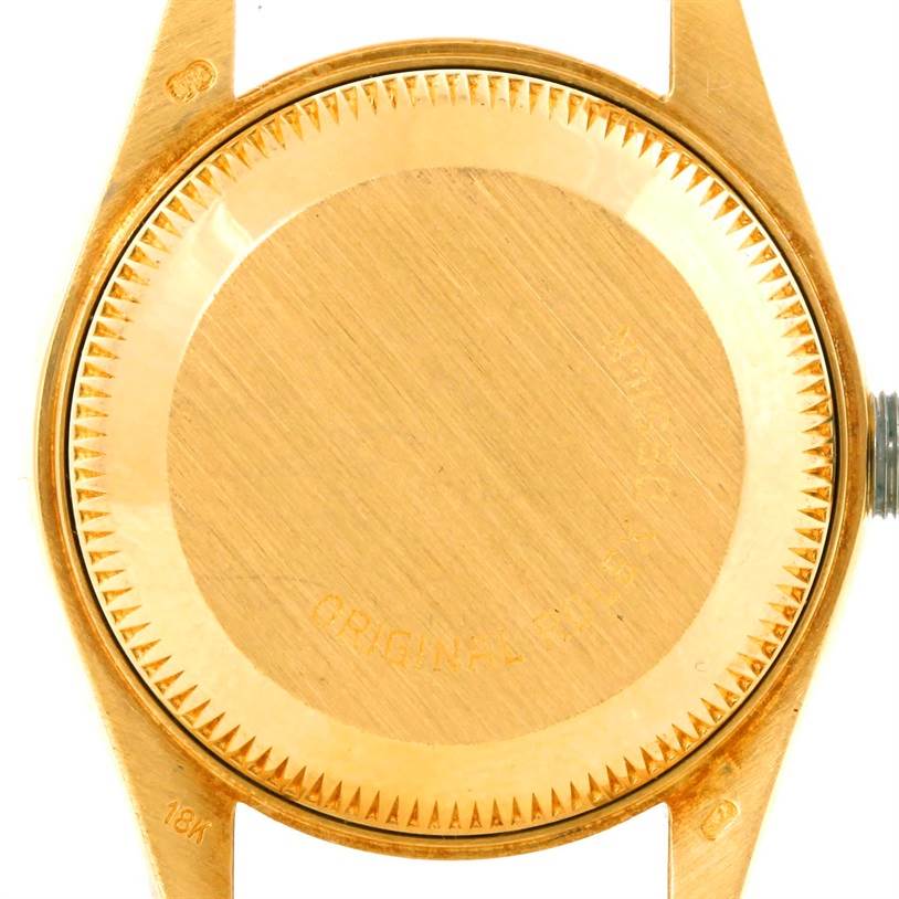 The image shows the caseback of a Rolex President 69178 Women's Yellow Gold Champagne Dial 69178 Women's Yellow Gold Champagne Dial model watch in a close-up, revealing the 18k gold material.
