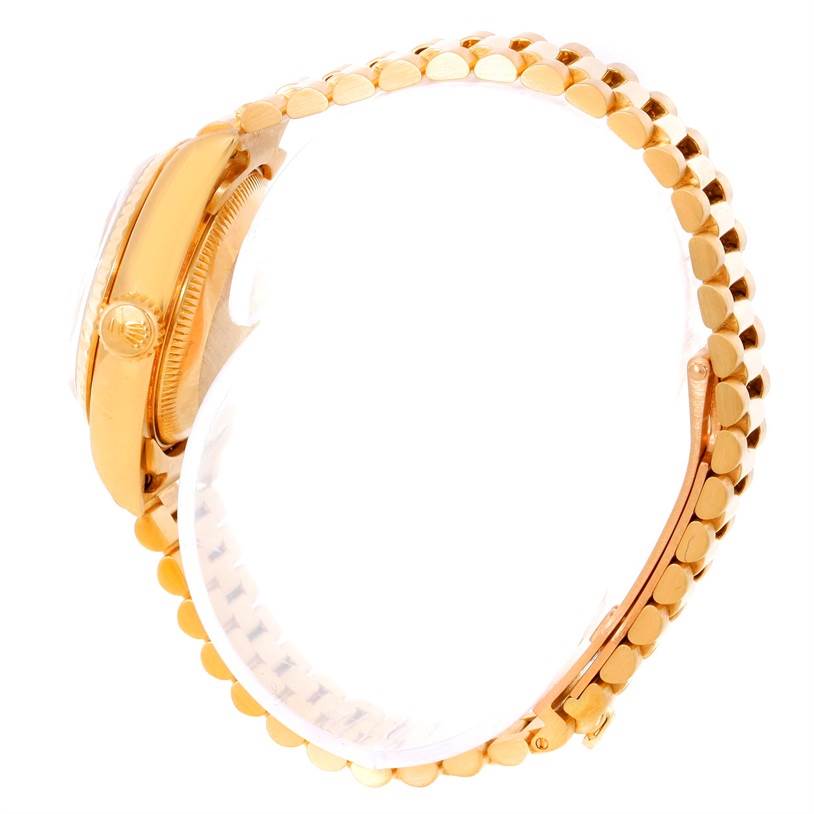 This side-angle image of the Rolex President 69178 Women's Yellow Gold Champagne Dial 69178 Women's Yellow Gold Champagne Dial watch showcases the crown, case, and part of the bracelet.