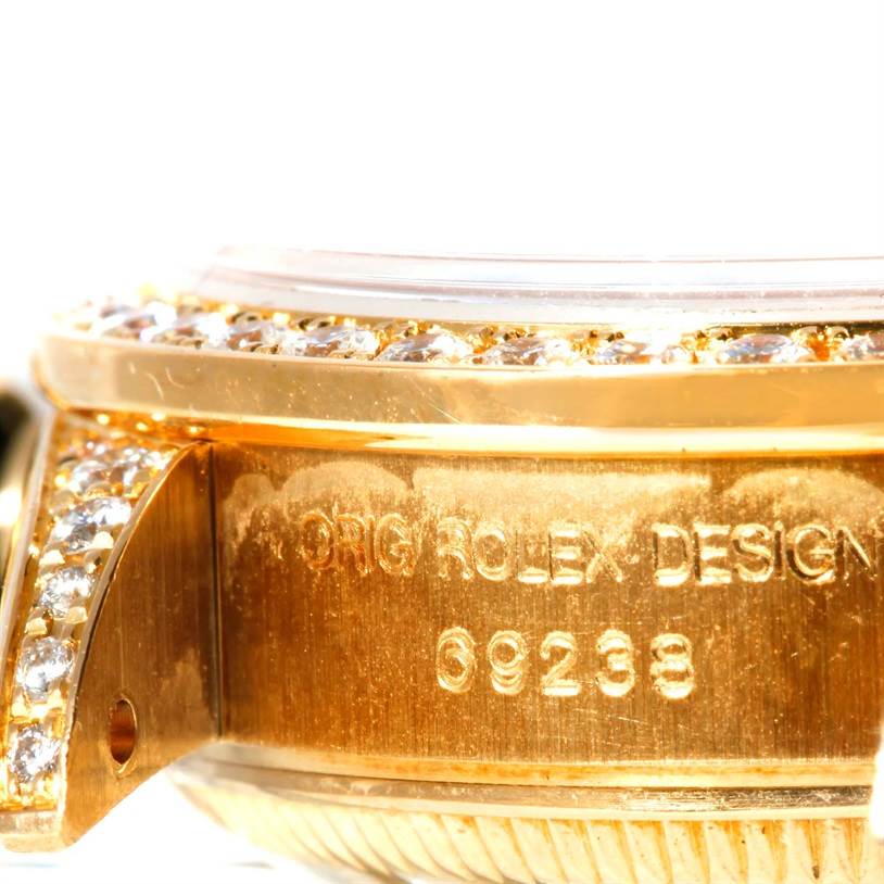 The image shows a close-up of the side of a Rolex President 69238 Women's Yellow Gold Champagne Dial 69238 Women's Yellow Gold Champagne Dial model watch, highlighting the bezel, diamonds, and case.