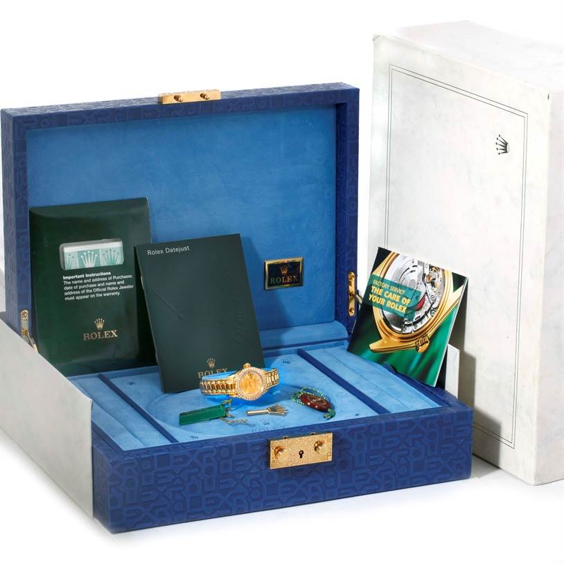 The image shows a Rolex President 69238 Women's Yellow Gold Champagne Dial 69238 Women's Yellow Gold Champagne Dial model watch and accessories including booklets and tags, all inside an open presentation box.