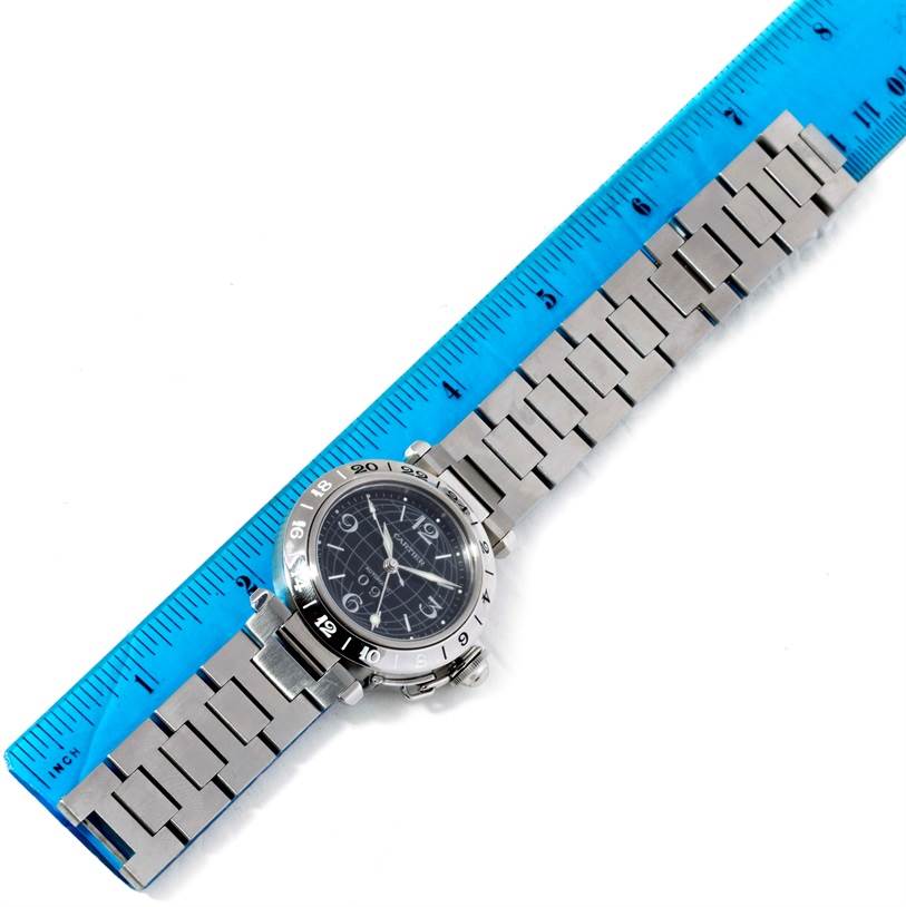 The Cartier Pasha W31049M7 Men's Stainless Steel Black Dial W31049M7 Men's Stainless Steel Black Dial watch is displayed flat with its stainless steel band aligned with a blue ruler for size reference.