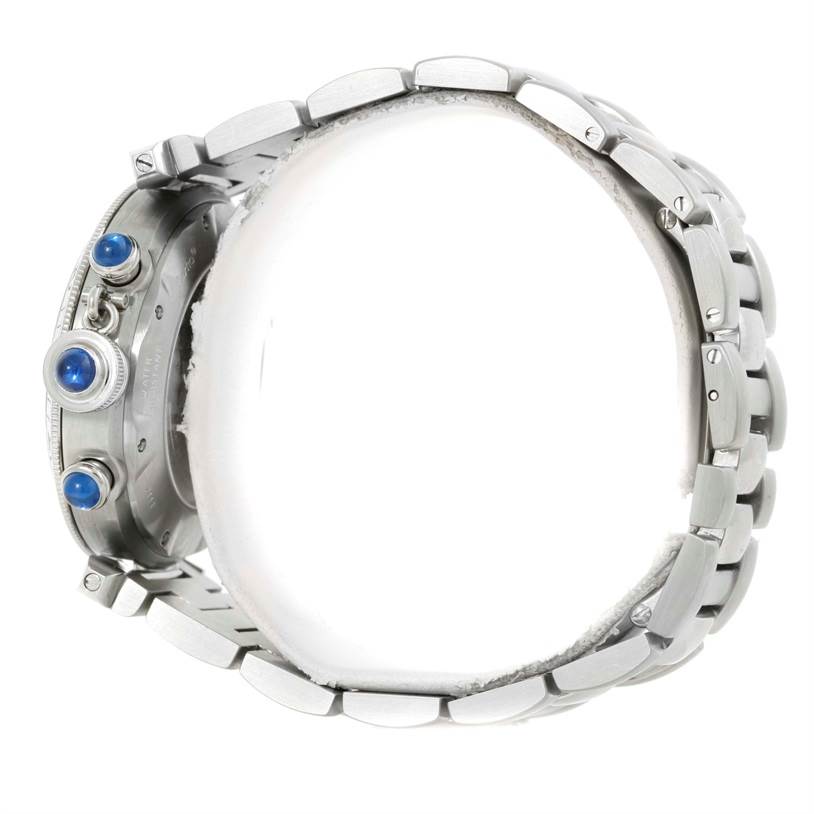 This image shows a side view of the Cartier Pasha W31030H3 Men
s Stainless Steel Silver Dial W31030H3 Men
s Stainless Steel Silver Dial watch, highlighting its bracelet, crown, and chronograph pushers with blue cabochons.