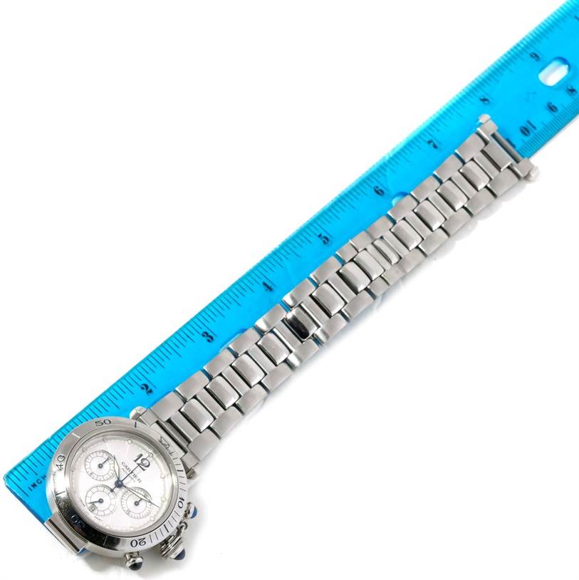 The Cartier Pasha W31030H3 Men
s Stainless Steel Silver Dial W31030H3 Men
s Stainless Steel Silver Dial watch is shown from a top view, alongside a ruler to measure its stainless steel bracelet.