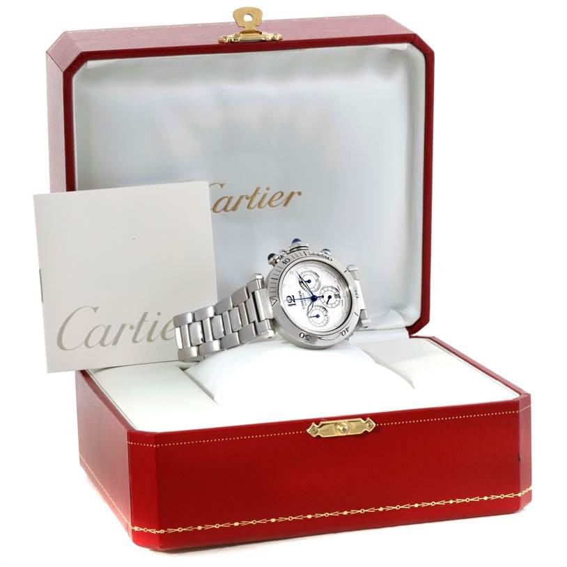 The Cartier Pasha W31030H3 Men
s Stainless Steel Silver Dial W31030H3 Men
s Stainless Steel Silver Dial model watch is shown inside an open red presentation box with a booklet beside it.