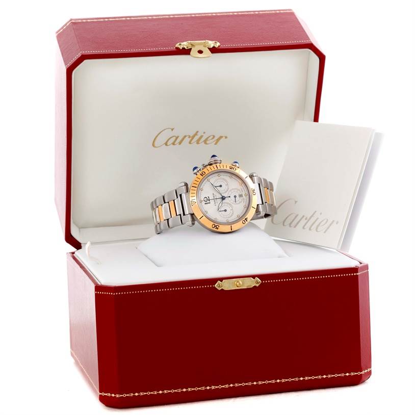 The Cartier Pasha W31036T6 Stainless Steel Silver Dial W31036T6 Stainless Steel Silver Dial watch is shown from the front inside an open Cartier box with a booklet beside it.