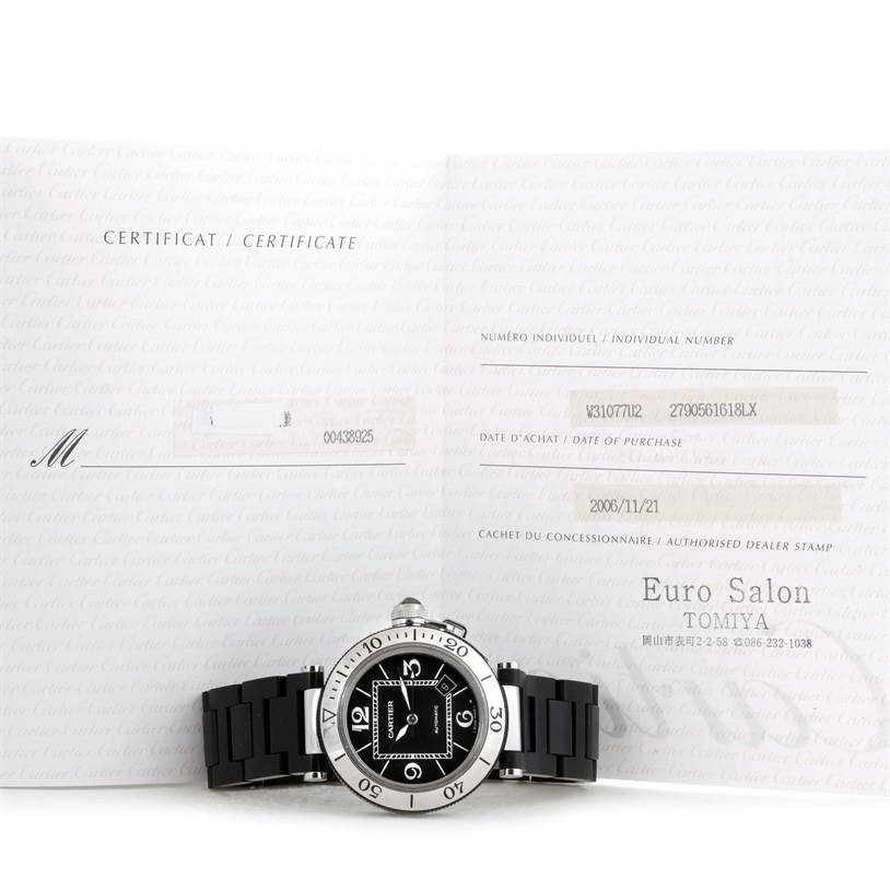 The Cartier Pasha W31077U2 Men's Stainless Steel Black Dial W31077U2 Men's Stainless Steel Black Dial watch is shown from the front, placed in front of its open certificate booklet.