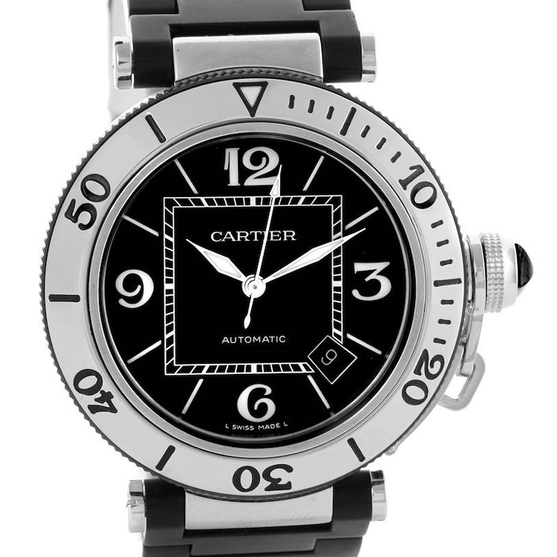 The Cartier Pasha watch is shown from a front angle, displaying its black dial, numerals, date window, bezel, and bracelet.