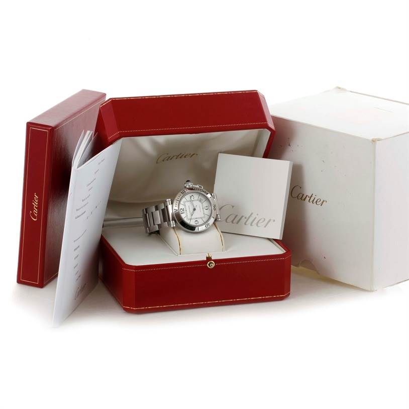 The Cartier Pasha W31080M7 Men's Stainless Steel Silver Dial W31080M7 Men's Stainless Steel Silver Dial watch is shown in its case with booklets, positioned at a slight angle to display its face and bracelet.