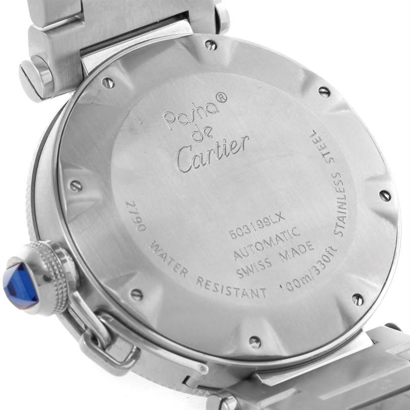 The image shows the back case and the crown with a blue gemstone of the Pasha de Cartier watch at an angled close-up view.