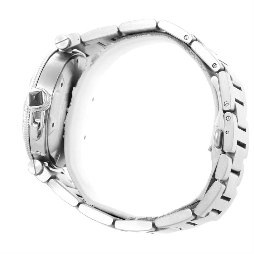 This Pasha model by Cartier is shown from a side angle, highlighting its crown, bezel, and metal bracelet.