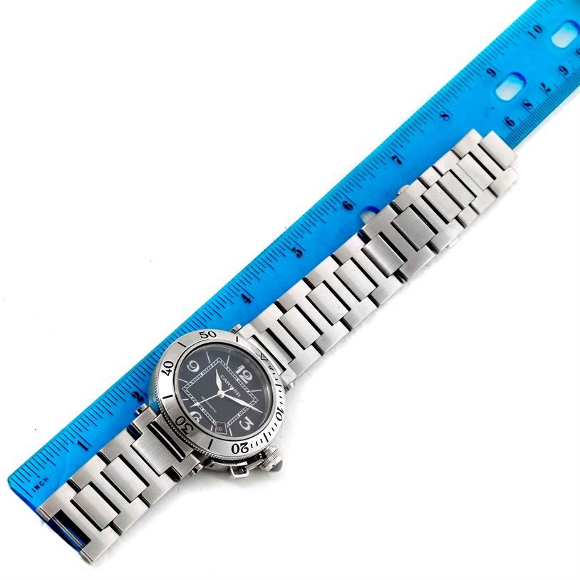 This image shows the full length of a Cartier Pasha W31077M7 Men
s Stainless Steel Black Dial W31077M7 Men
s Stainless Steel Black Dial watch laid next to a blue ruler for measurement.