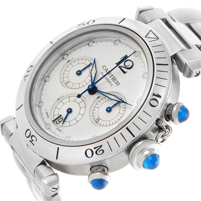 The image shows a close-up of the Cartier Pasha W31030H3 Men's Stainless Steel Silver Dial W31030H3 Men's Stainless Steel Silver Dial watch's face, bezel, and part of its bracelet from an angled perspective.