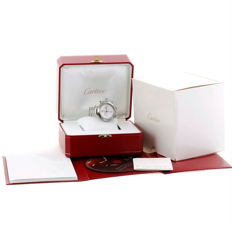 The image shows a Cartier Pasha W31030H3 Men's Stainless Steel Silver Dial W31030H3 Men's Stainless Steel Silver Dial watch displayed in an open red box with its accessories and outer packaging.