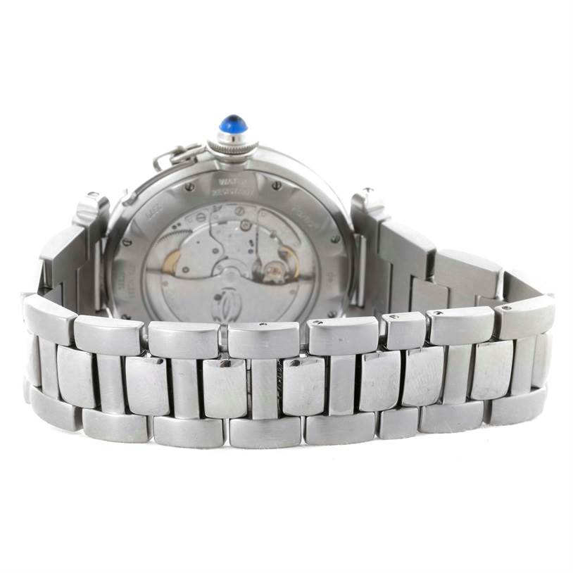 The image shows the back view of the Pasha model by Cartier, highlighting the metallic bracelet and movement mechanism.
