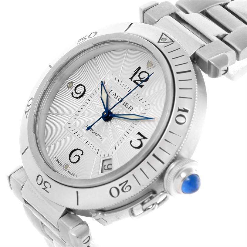 The image shows a close-up, angled view of the Cartier Pasha W3103155 Men
s Stainless Steel Silver Dial W3103155 Men
s Stainless Steel Silver Dial watch, highlighting the dial, bezel, and crown with a blue cabochon.