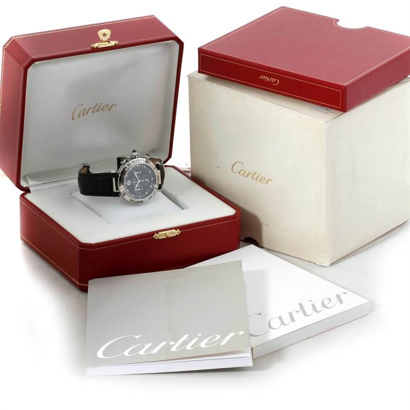 The Cartier Pasha W3105155 Men's Stainless Steel Grey Dial W3105155 Men's Stainless Steel Grey Dial watch is shown in its open, red display box alongside an outer box and branded booklets.