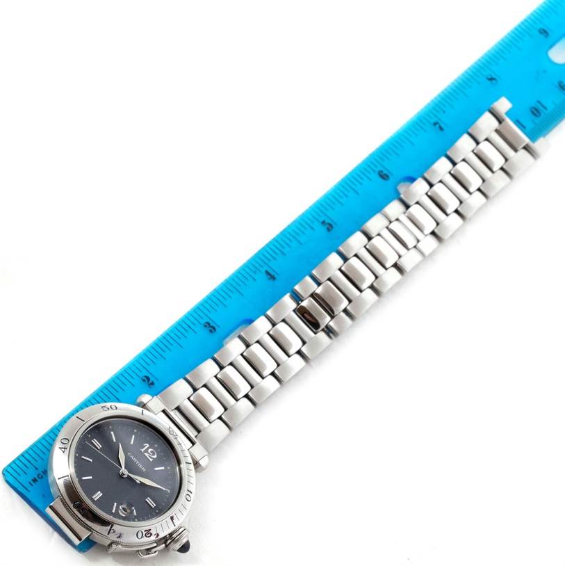 The Cartier Pasha W31017H3 Men's Stainless Steel Grey Dial W31017H3 Men's Stainless Steel Grey Dial watch is shown from a top-down angle alongside a blue measuring ruler.