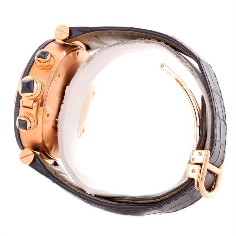 This side-angle view of a Cartier Pasha W3030018 Men's Rose Gold Black Dial W3030018 Men's Rose Gold Black Dial model watch shows the leather strap, gold detailing, and push buttons.