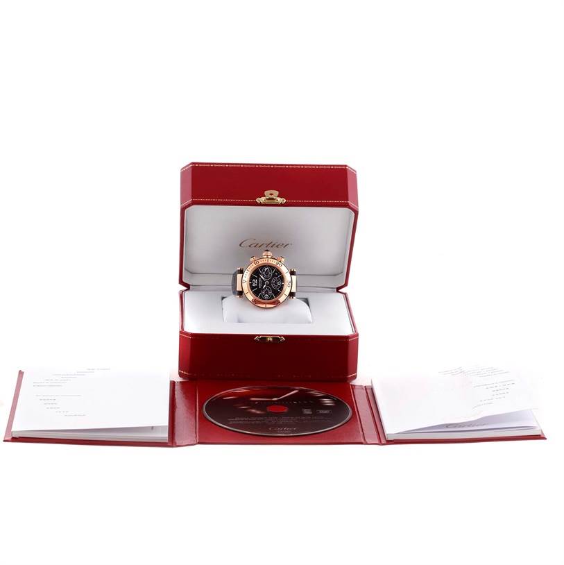 The image shows a Cartier Pasha W3030018 Men's Rose Gold Black Dial W3030018 Men's Rose Gold Black Dial model watch in an open red box, accompanied by a booklet and a CD.