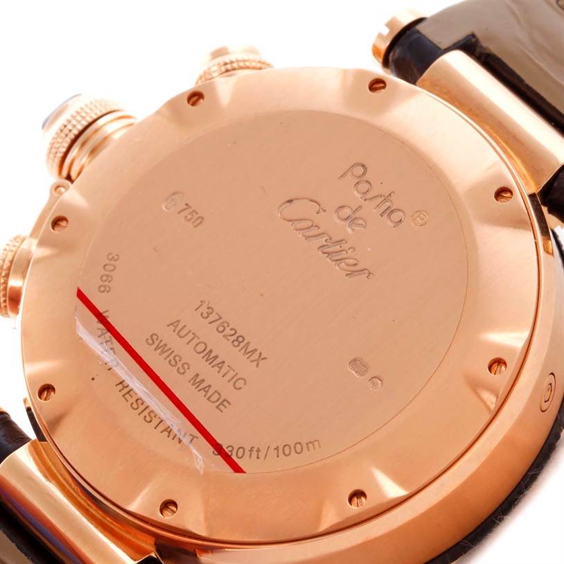 The image shows the case back of the Cartier Pasha W3030018 Men's Rose Gold Black Dial W3030018 Men's Rose Gold Black Dial model watch, displaying its engravings and some parts of the strap and crown.