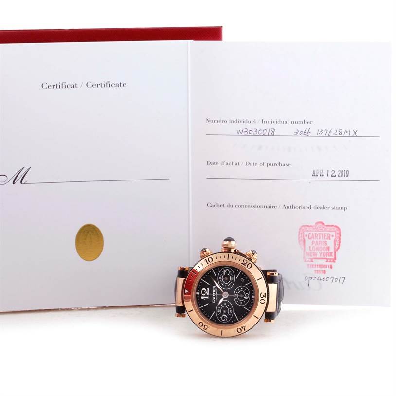 The image shows a Cartier Pasha W3030018 Men's Rose Gold Black Dial W3030018 Men's Rose Gold Black Dial watch facing front, placed in front of its certificate documents.