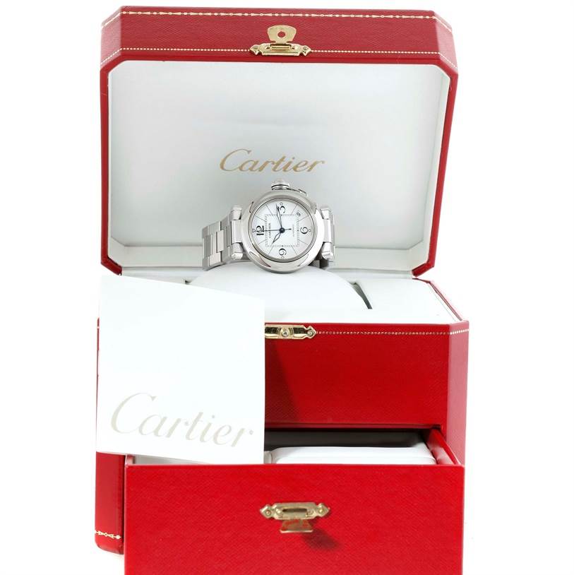 The Cartier Pasha W31074M7 Men's Stainless Steel White Dial W31074M7 Men's Stainless Steel White Dial watch is displayed front-facing in an open red box with the Cartier logo inside.