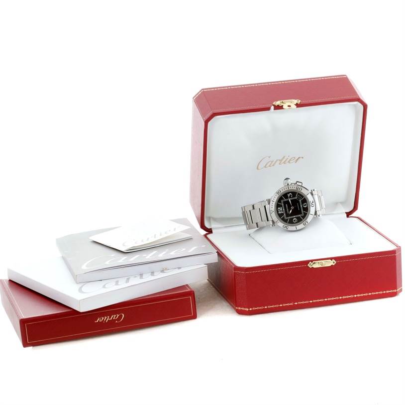 The image shows a Cartier
s Pasha model watch displayed in an open red box with accompanying booklets beside it.