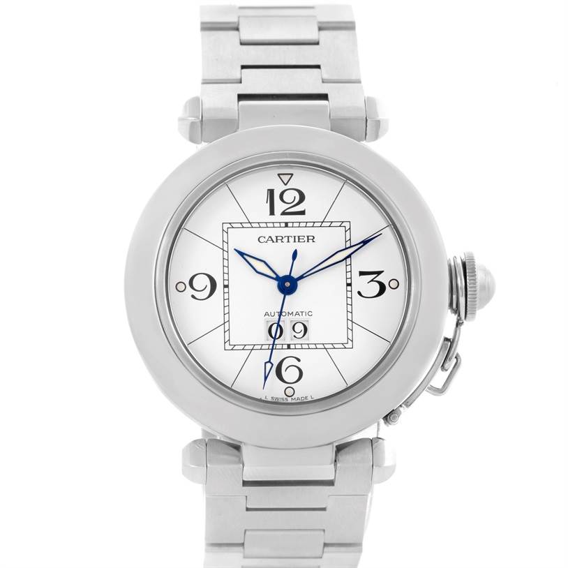 The image shows a front view of the Pasha model by Cartier, highlighting the watch face, blue hands, and part of the stainless steel bracelet.