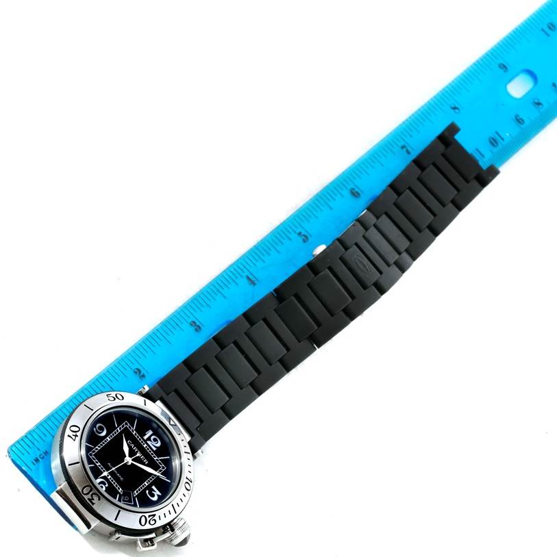The image shows a Pasha watch by Cartier from the top view, partially measured against a blue ruler.