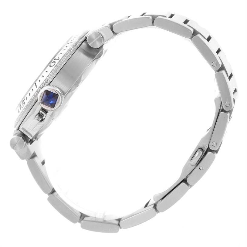 The image shows a side profile of the Cartier Pasha W31080M7 Men's Stainless Steel Silver Dial W31080M7 Men's Stainless Steel Silver Dial watch, highlighting its crown with a blue gem and metal bracelet.