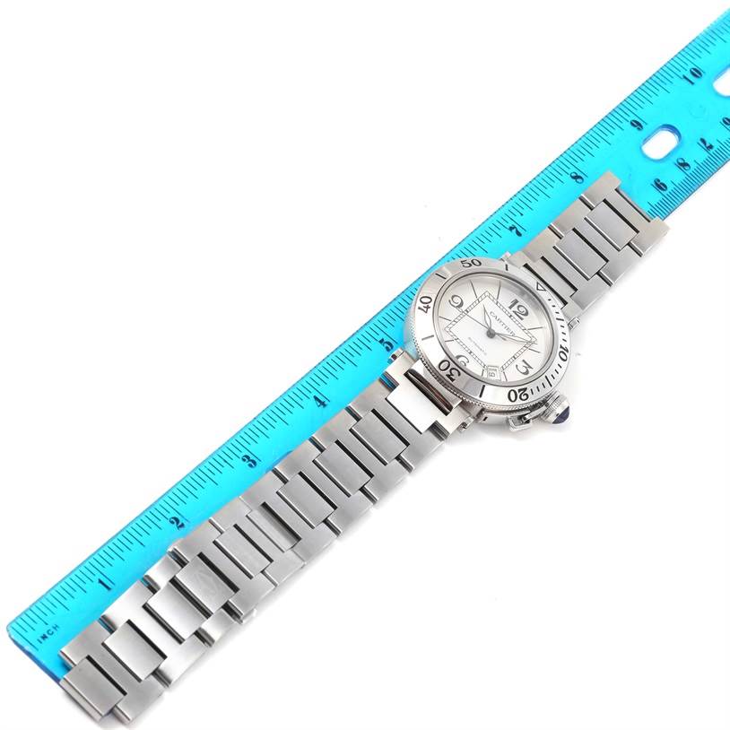 This image shows a Cartier Pasha W31080M7 Men
s Stainless Steel Silver Dial W31080M7 Men
s Stainless Steel Silver Dial watch horizontally, with a ruler measuring its bracelet and watch face.