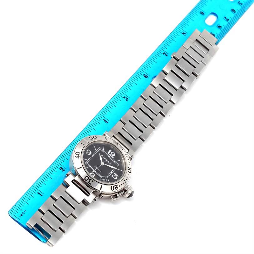 The Cartier Pasha W31077M7 Men
s Stainless Steel Black Dial W31077M7 Men
s Stainless Steel Black Dial watch is shown lying flat and measured with a blue ruler, highlighting its face and metal bracelet.