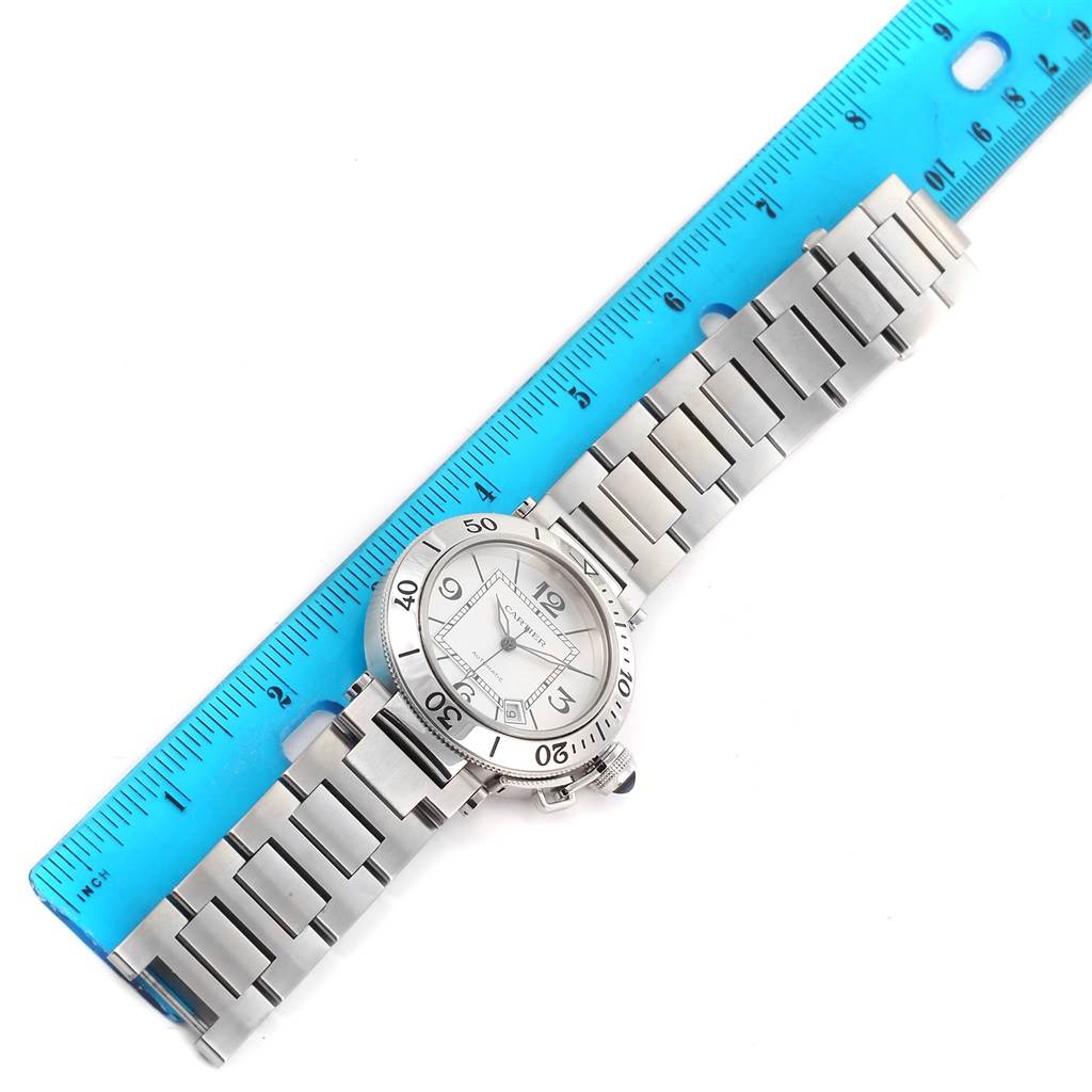 The Cartier Pasha W31080M7 Men
s Stainless Steel Silver Dial W31080M7 Men
s Stainless Steel Silver Dial watch is shown lying flat with its stainless steel bracelet extended and a ruler for scale.